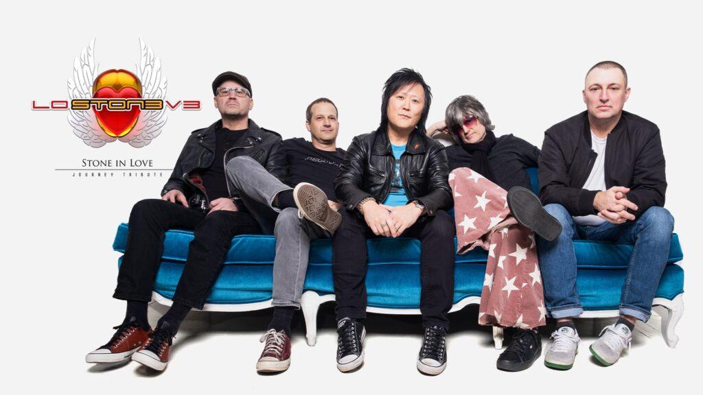 Band sitting on blue sofa